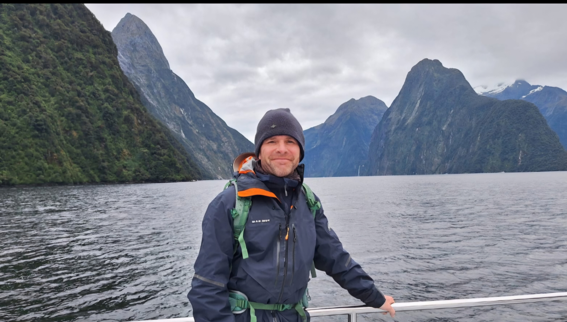 On a boat in Milford Sound with dramatic mountains rising from the water